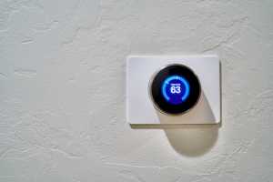Programmable digital thermostat, on a clean white wall